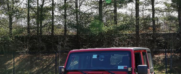 red jeep wrangler on forest during daytime