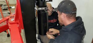 Olympic Equipment lift specialists working at a lift power unit